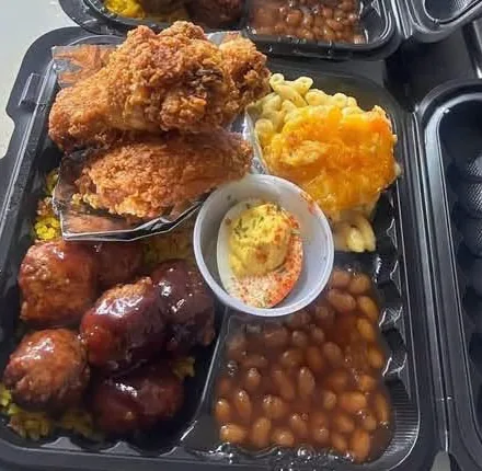 Fried chicken plate with sides in a to-go container