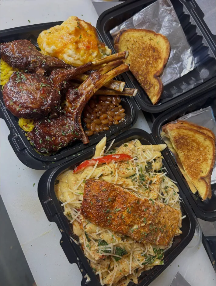 Lamb chops with yellow rice, baked beans and mac and cheese, next to salmon over pasta and Texas toast